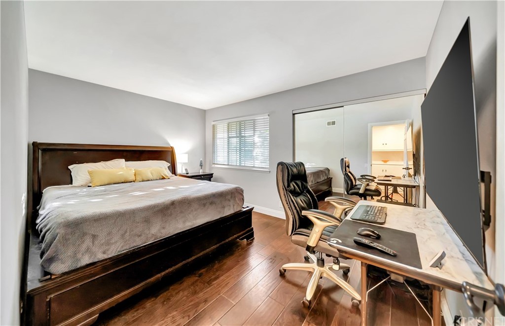 7078 Deveron Ridge Road West Hills, CA 91307 - Photo 31 of 62 a bedroom with a bed and wooden floor