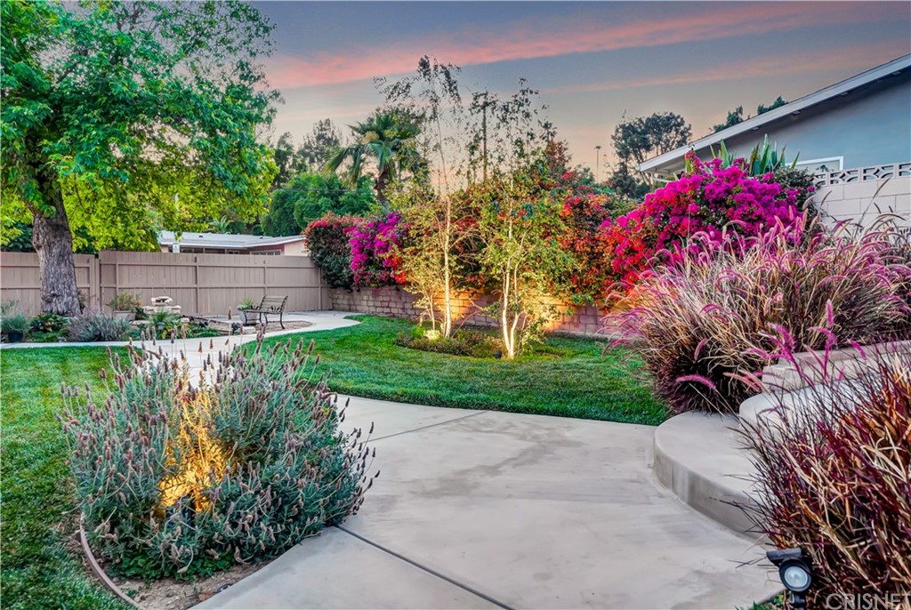 7078 Deveron Ridge Road West Hills, CA 91307 - Photo 39 of 62 a front view of a house with a yard and fountain in middle of the road