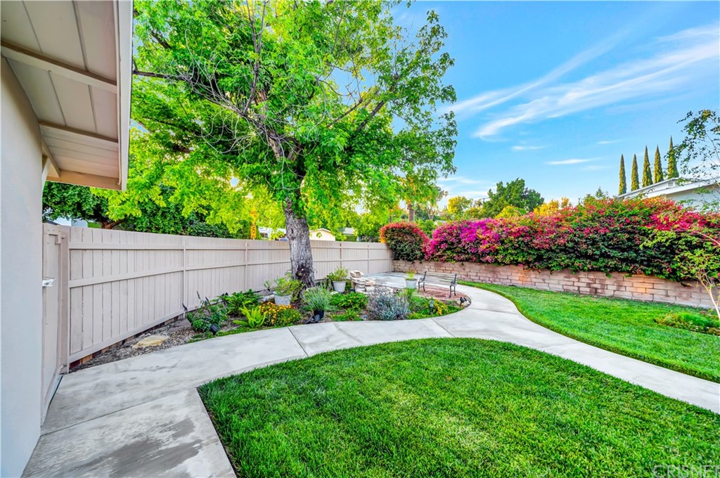 7078 Deveron Ridge Road West Hills, CA 91307 - Photo 42 of 62 a view of a garden with flowers and a bench