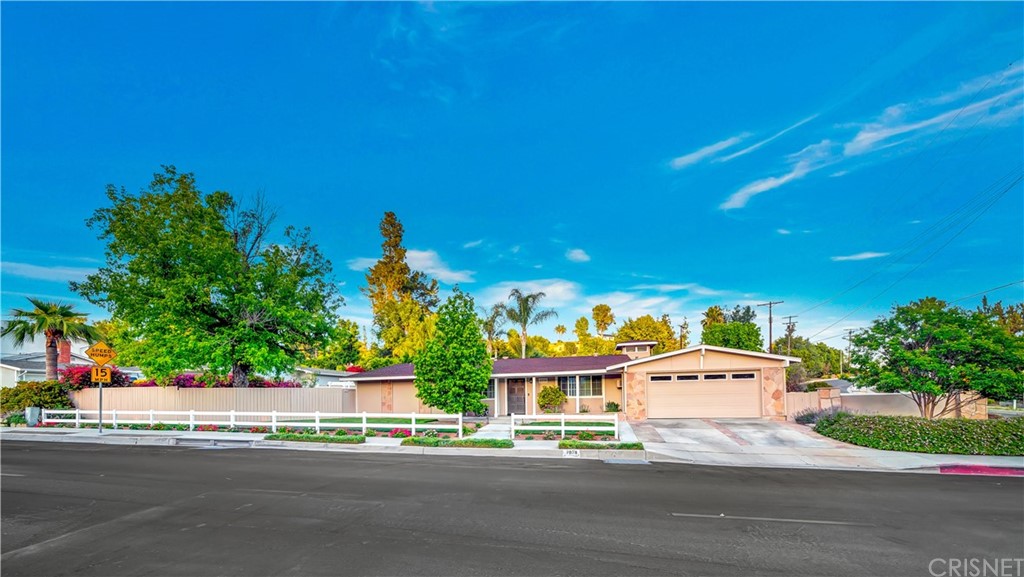7078 Deveron Ridge Road West Hills, CA 91307 - Photo 48 of 62 a front view of a house with a yard and garage