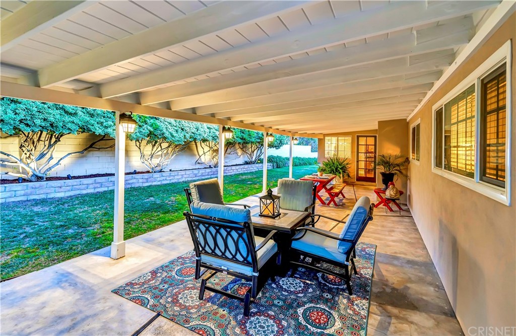 7078 Deveron Ridge Road West Hills, CA 91307 - Photo 56 of 62 a view of a patio with a table chairs and a backyard