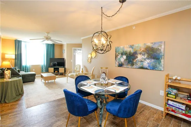 a living room with furniture a rug and a floor to ceiling window