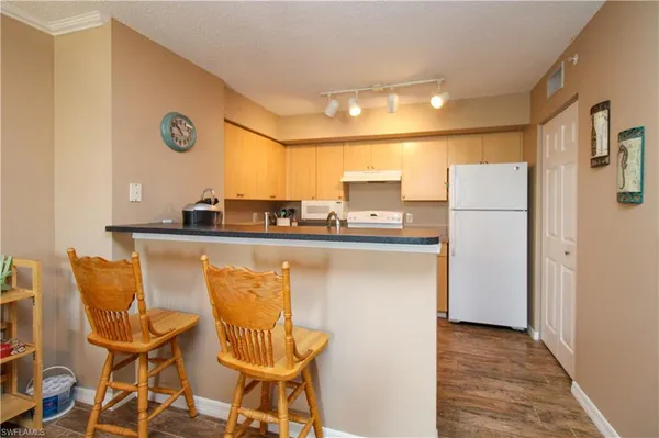a kitchen with stainless steel appliances a refrigerator and a table