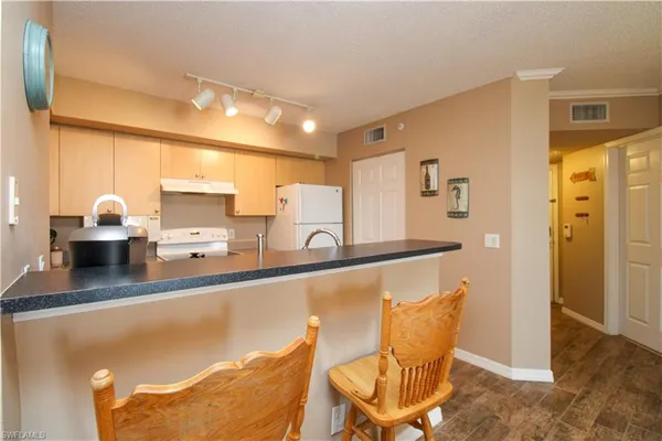 a kitchen with stainless steel appliances kitchen island granite countertop a sink and cabinets