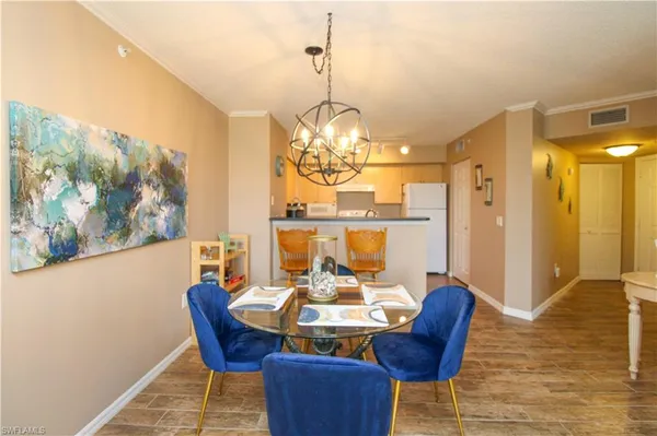 a view of a dining room with furniture wooden floor and a chandelier