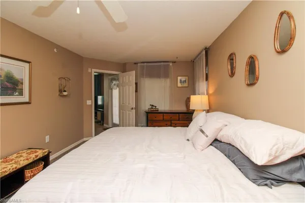 a bedroom with a bed and a lamp