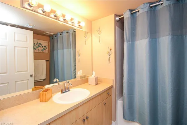 a bathroom with a double vanity sink and mirror