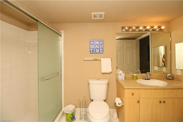 a bathroom with a sink mirror vanity and toilet