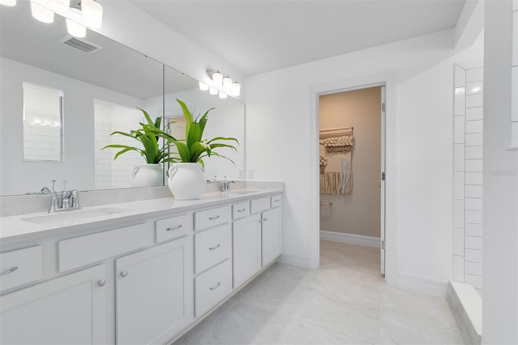 15130 Willow Ridge Drive Montverde, FL 34756 - Photo 18 of 27 a bathroom with a granite countertop sink a mirror and a potted plant