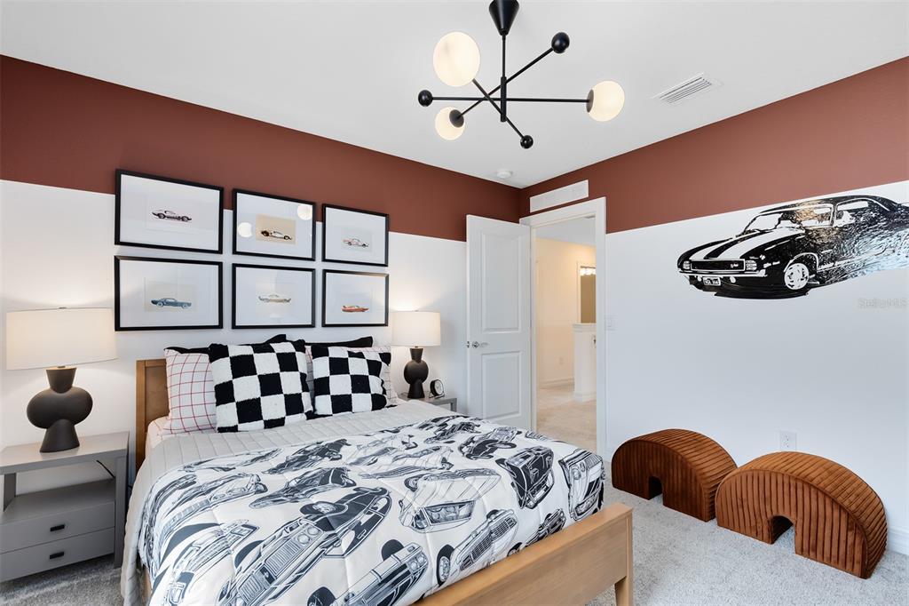 15130 Willow Ridge Drive Montverde, FL 34756 - Photo 23 of 27 a bedroom with a bed and a chandelier