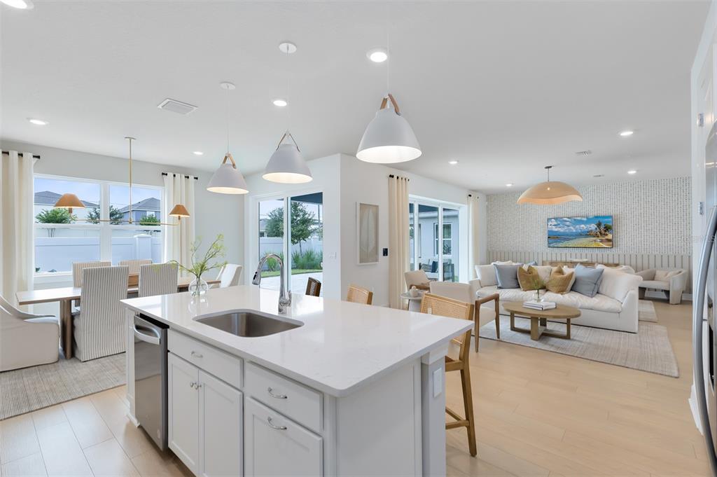 15130 Willow Ridge Drive Montverde, FL 34756 - Photo 6 of 27 a large kitchen with kitchen island a large counter top space a sink stainless steel appliances and cabinets