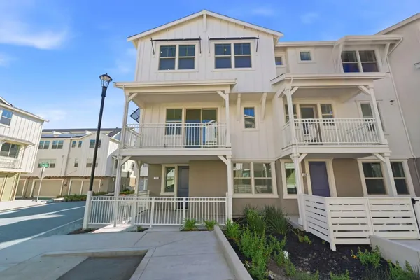 a front view of a residential apartment building with a yard