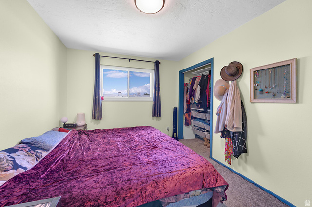 88 West 700 South Payson, UT 84651 - Photo 11 of 27 Bedroom featuring a closet, carpet flooring, and a textured ceiling