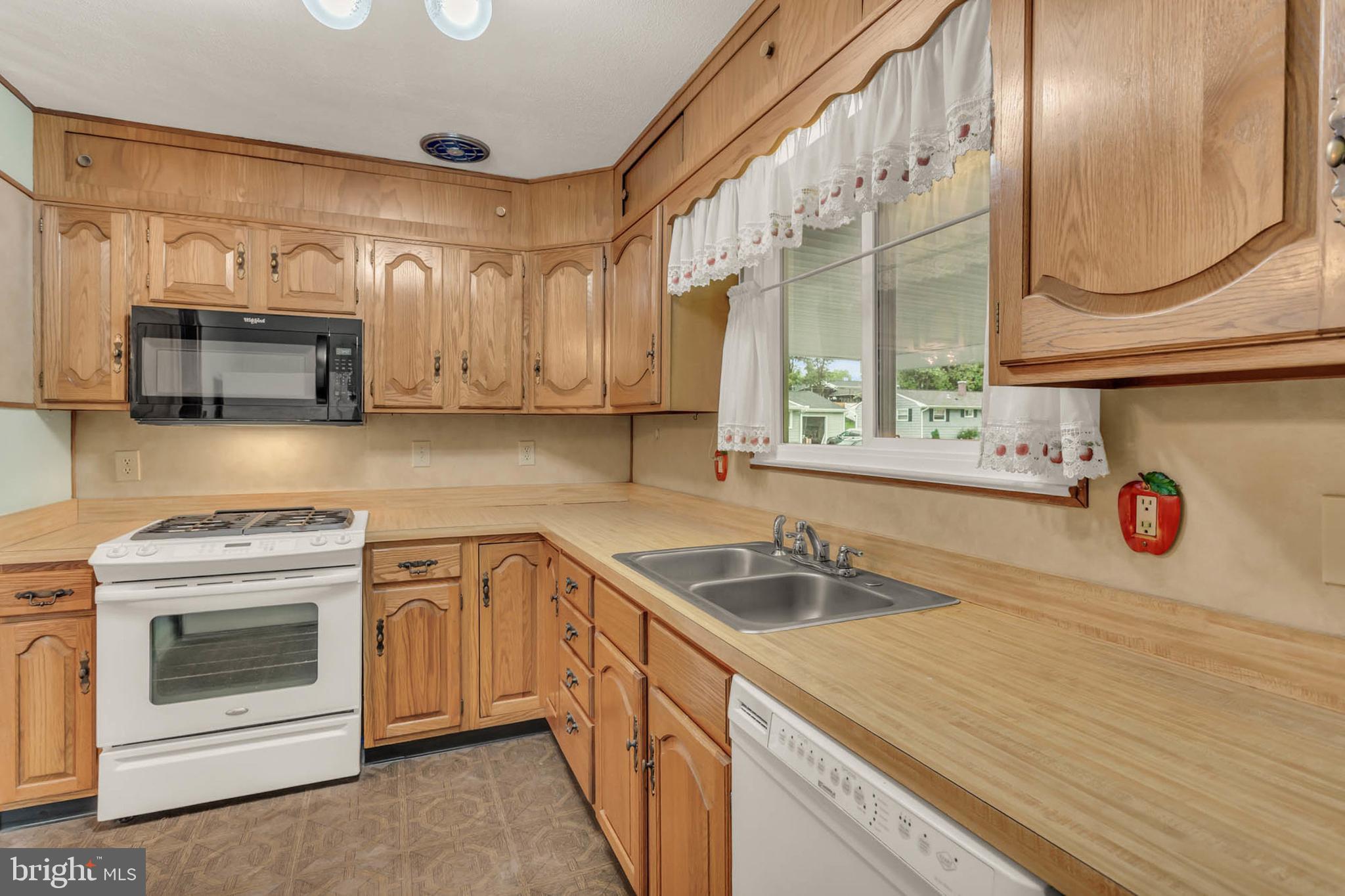 586 Rita Drive Odenton, MD 21113 - Photo 11 of 27 a kitchen with stainless steel appliances granite countertop a sink a stove and a microwave oven with cabinets