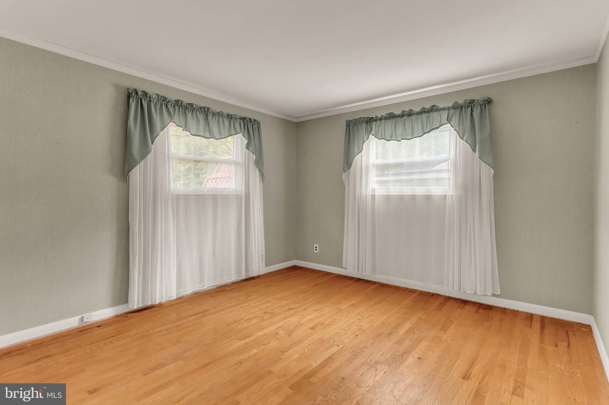 586 Rita Drive Odenton, MD 21113 - Photo 12 of 27 a view of an empty room with wooden floor and a window