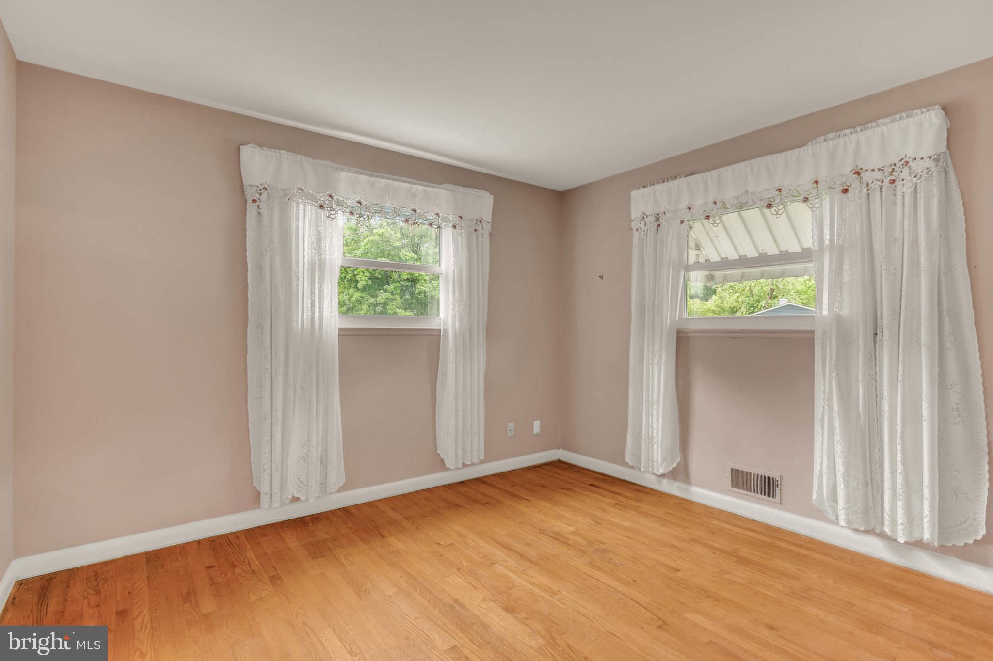 586 Rita Drive Odenton, MD 21113 - Photo 15 of 27 a view of an empty room with wooden floor and a window