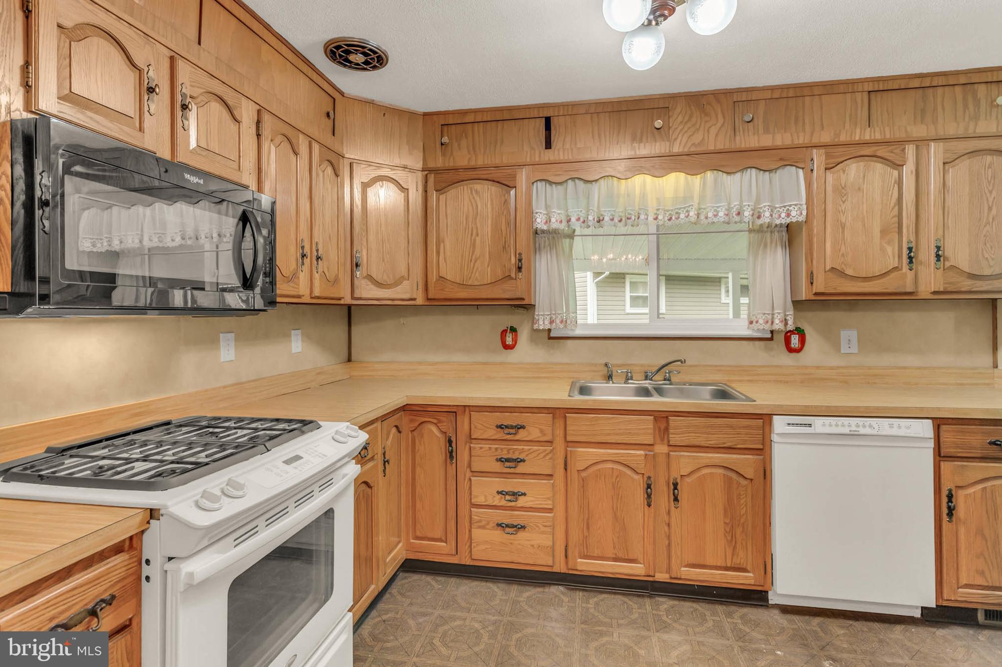 586 Rita Drive Odenton, MD 21113 - Photo 10 of 27 a kitchen with cabinets appliances a sink and a window