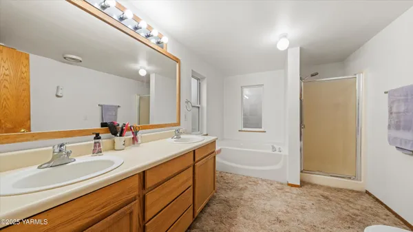 a bathroom with a granite countertop sink mirror and a bathtub
