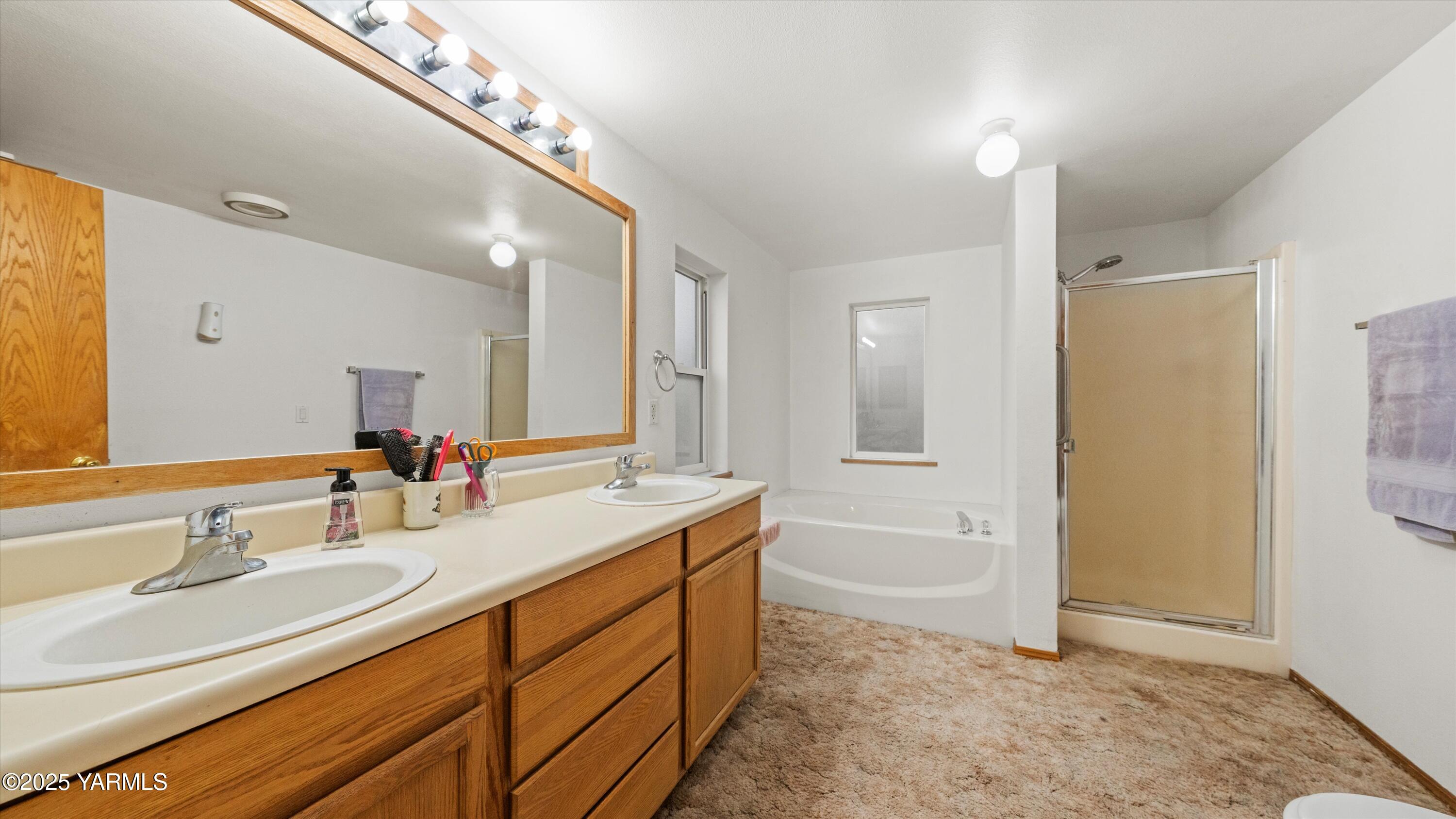 1200 Euclid Street, Unit 76 Grandview, WA 98930 - Photo 17 of 25 a bathroom with a granite countertop sink mirror and a bathtub
