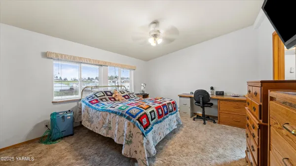 a bedroom with bed and window