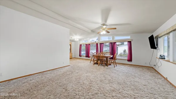 an empty room with furniture and a window