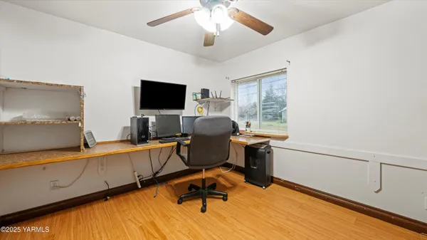 a view of a workspace with furniture and a window