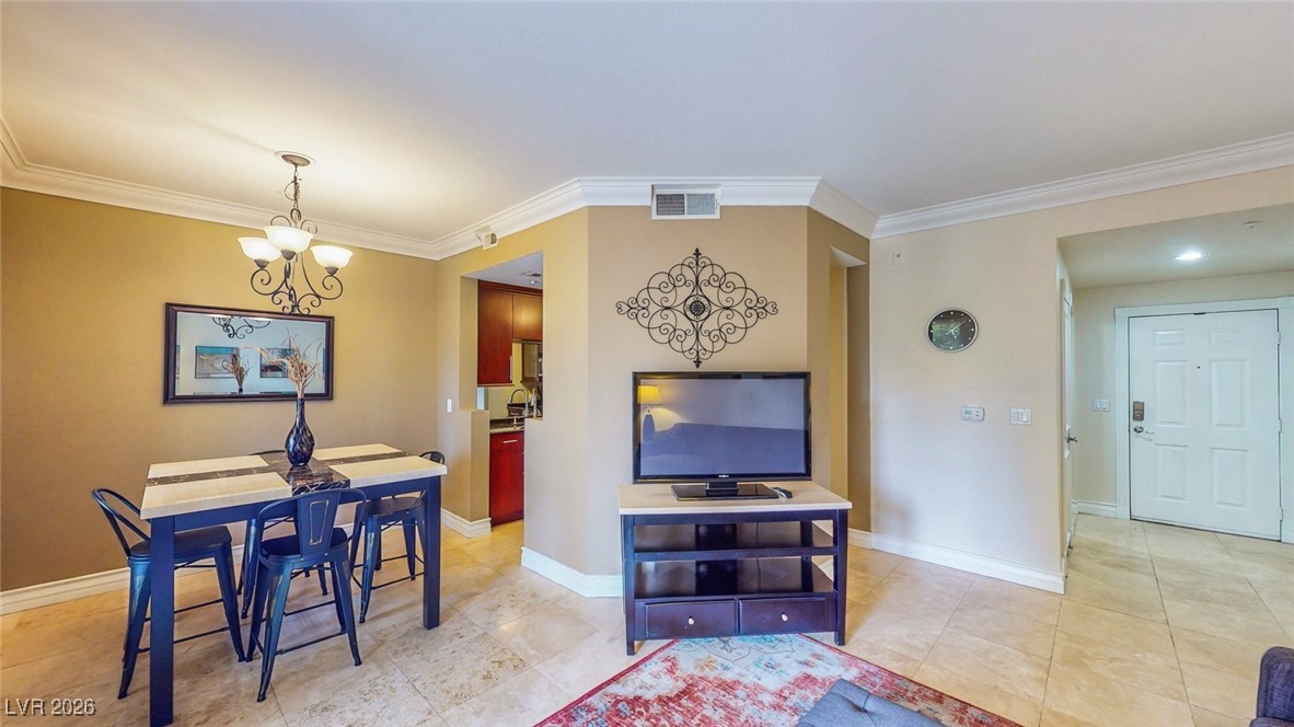 260 East Flamingo Road, Unit 229 Las Vegas, NV 89169 - Photo 13 of 31 Dining area with a chandelier and crown molding