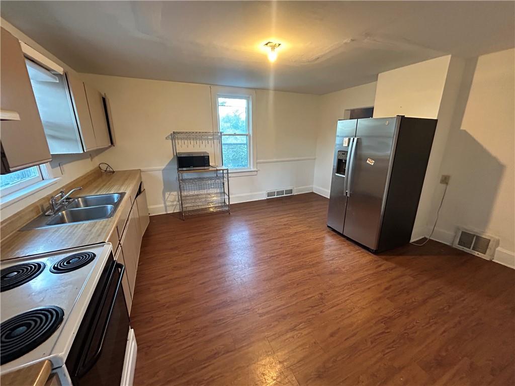 25 East Craig Street Uniontown, PA 15401 - Photo 9 of 18 a view of a refrigerator in kitchen and a wooden floor