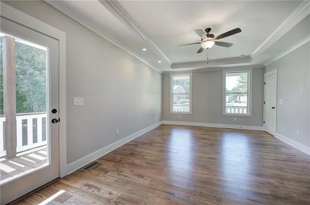 wooden floor in an empty room with a window