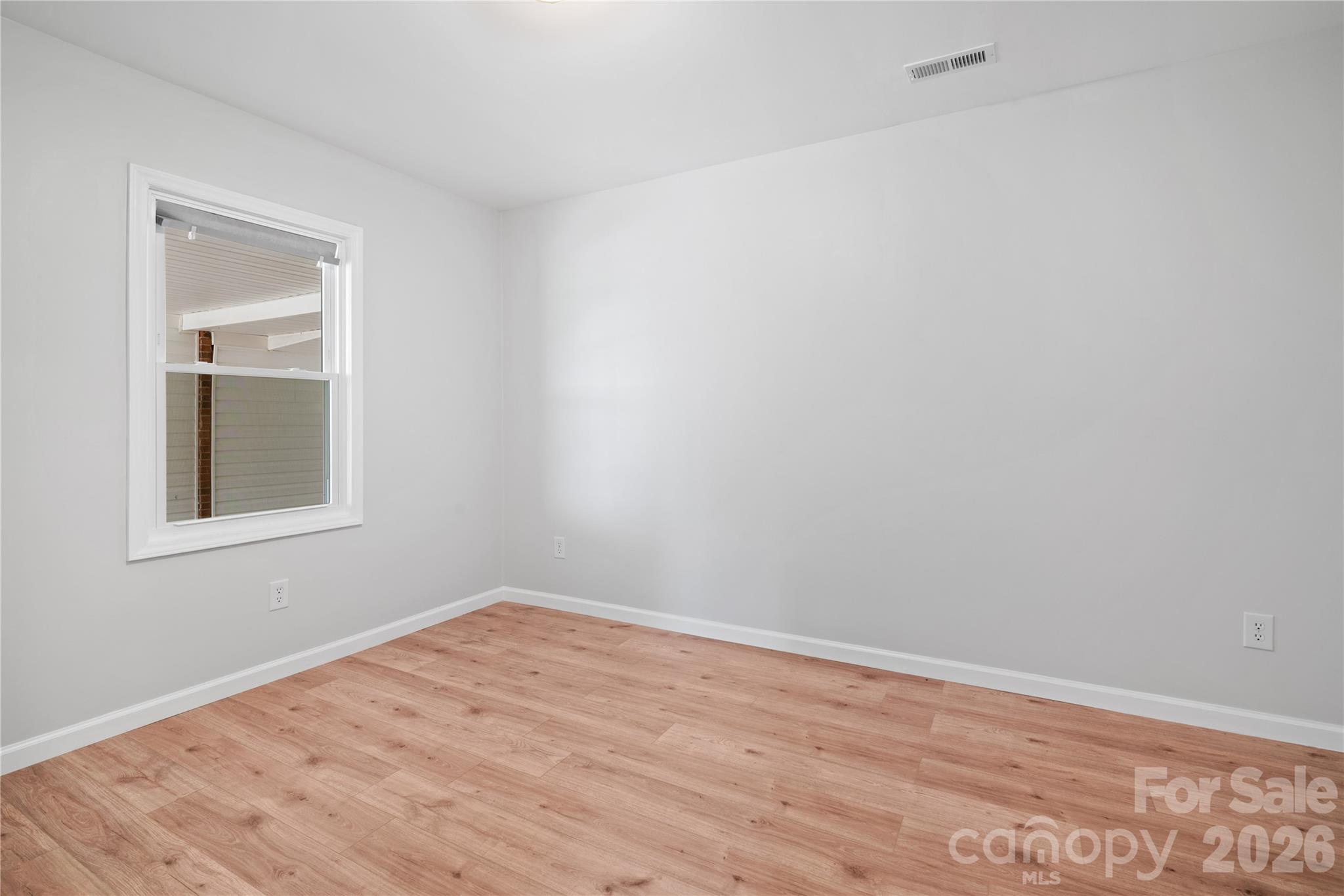 648 Scotts Creek Road Statesville, NC 28625 - Photo 11 of 17 a view of empty room with wooden floor and fan
