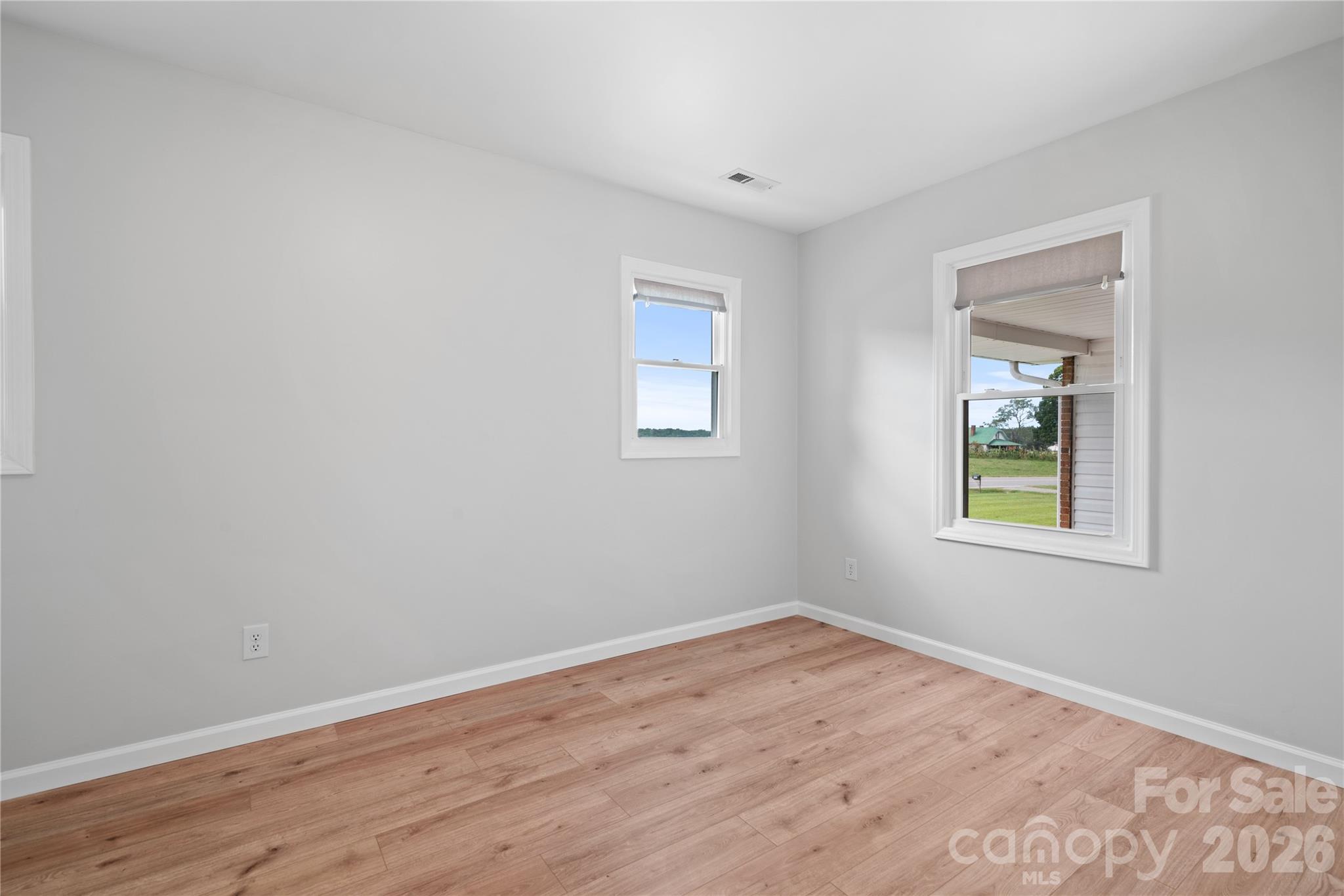 648 Scotts Creek Road Statesville, NC 28625 - Photo 12 of 17 a view of an empty room with wooden floor and a window
