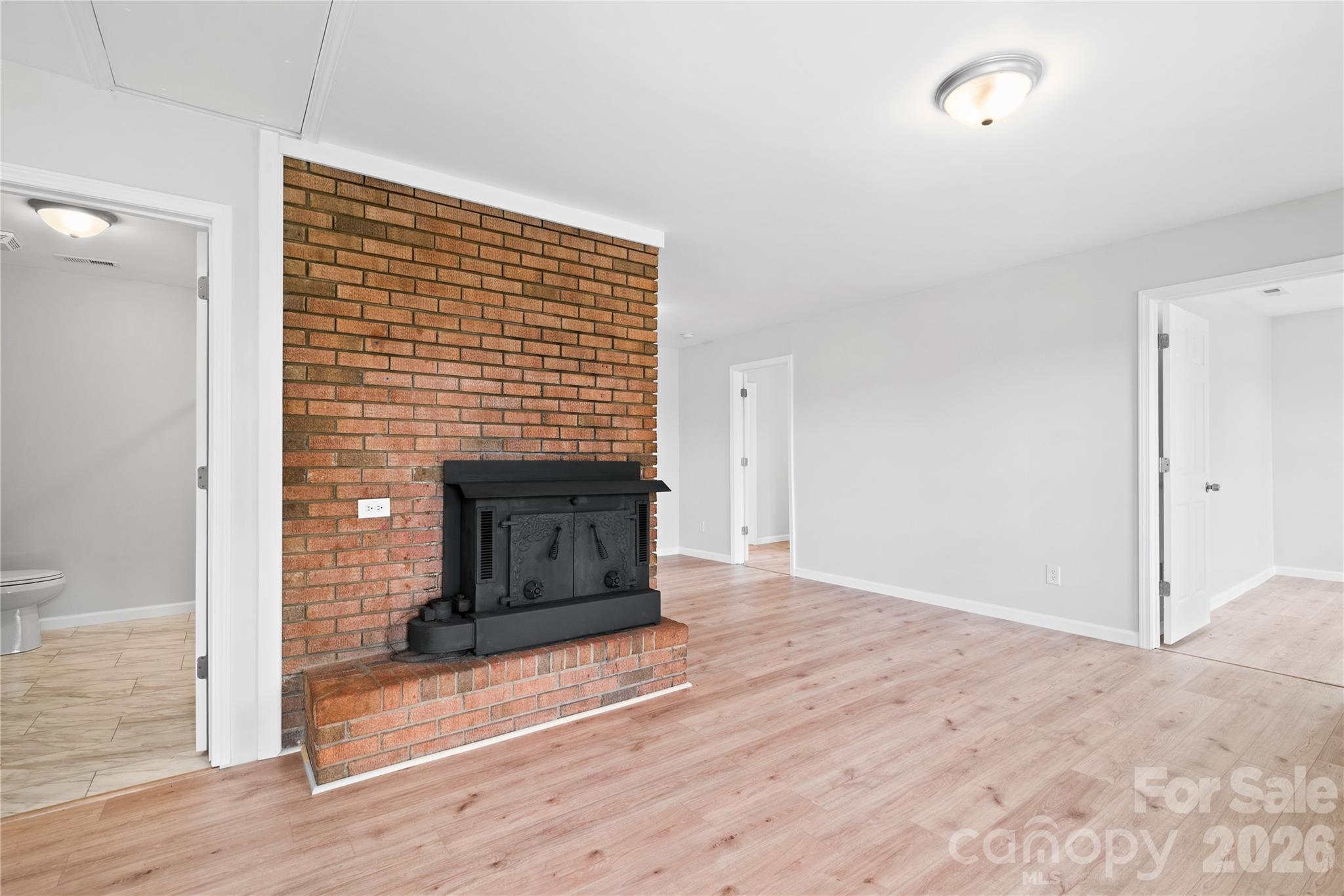 648 Scotts Creek Road Statesville, NC 28625 - Photo 5 of 17 a view of a livingroom with wooden floor and a fireplace