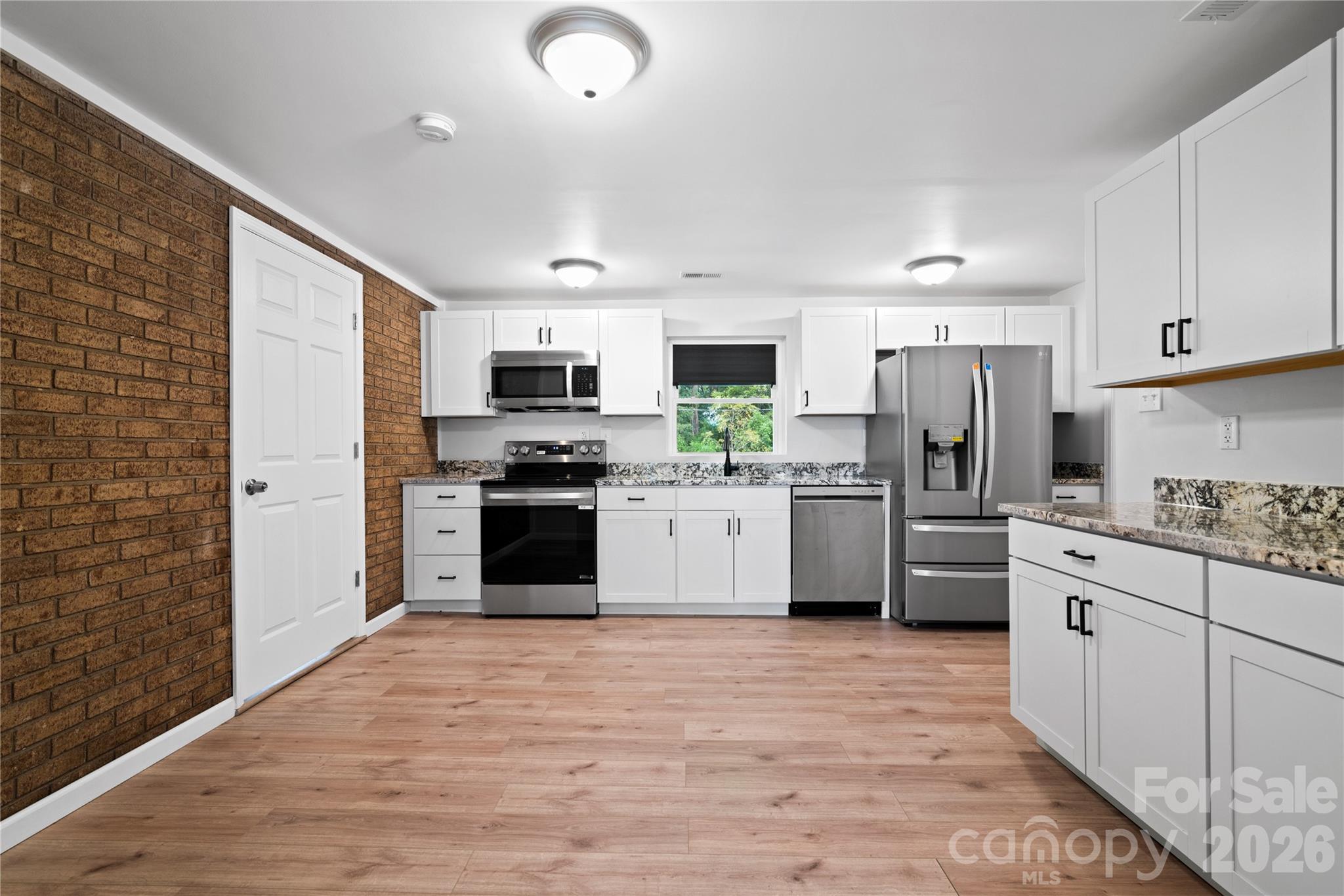 648 Scotts Creek Road Statesville, NC 28625 - Photo 6 of 17 a kitchen with stainless steel appliances a refrigerator sink stove oven and cabinets