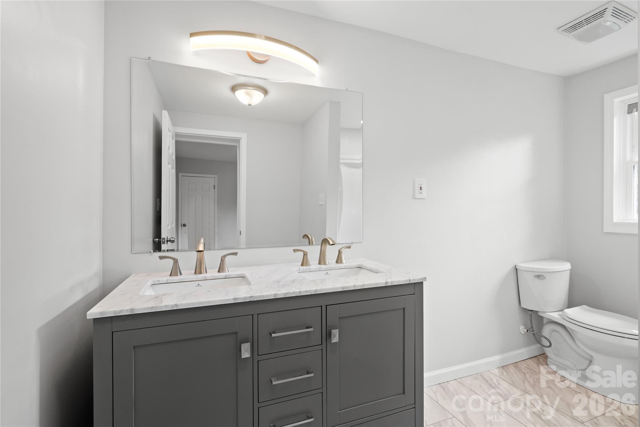648 Scotts Creek Road Statesville, NC 28625 - Photo 9 of 17 a bathroom with a toilet sink and mirror
