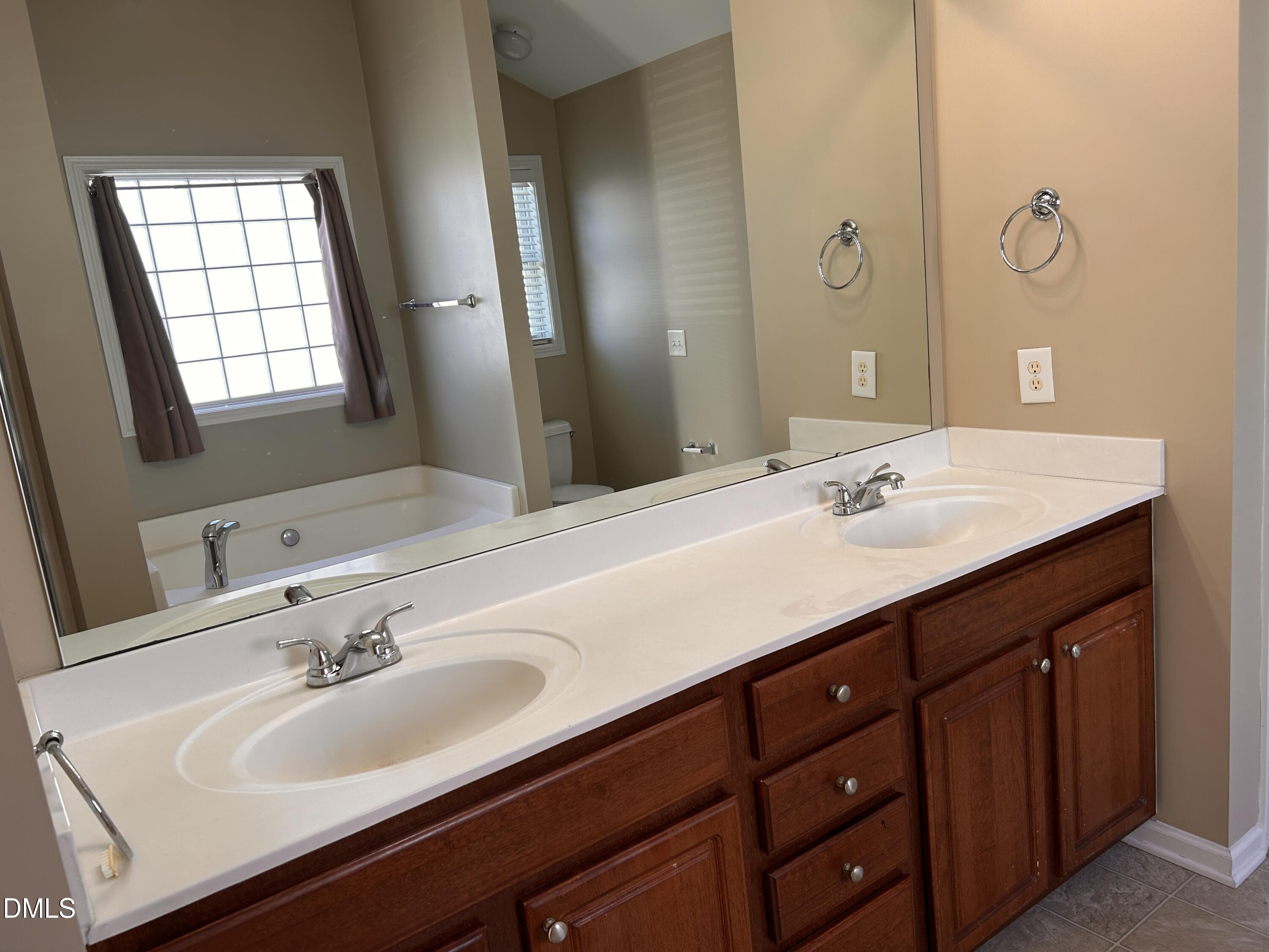 3920 Cane Garden Drive Raleigh, NC 27610 - Photo 14 of 23 a bathroom with a sink and a mirror
