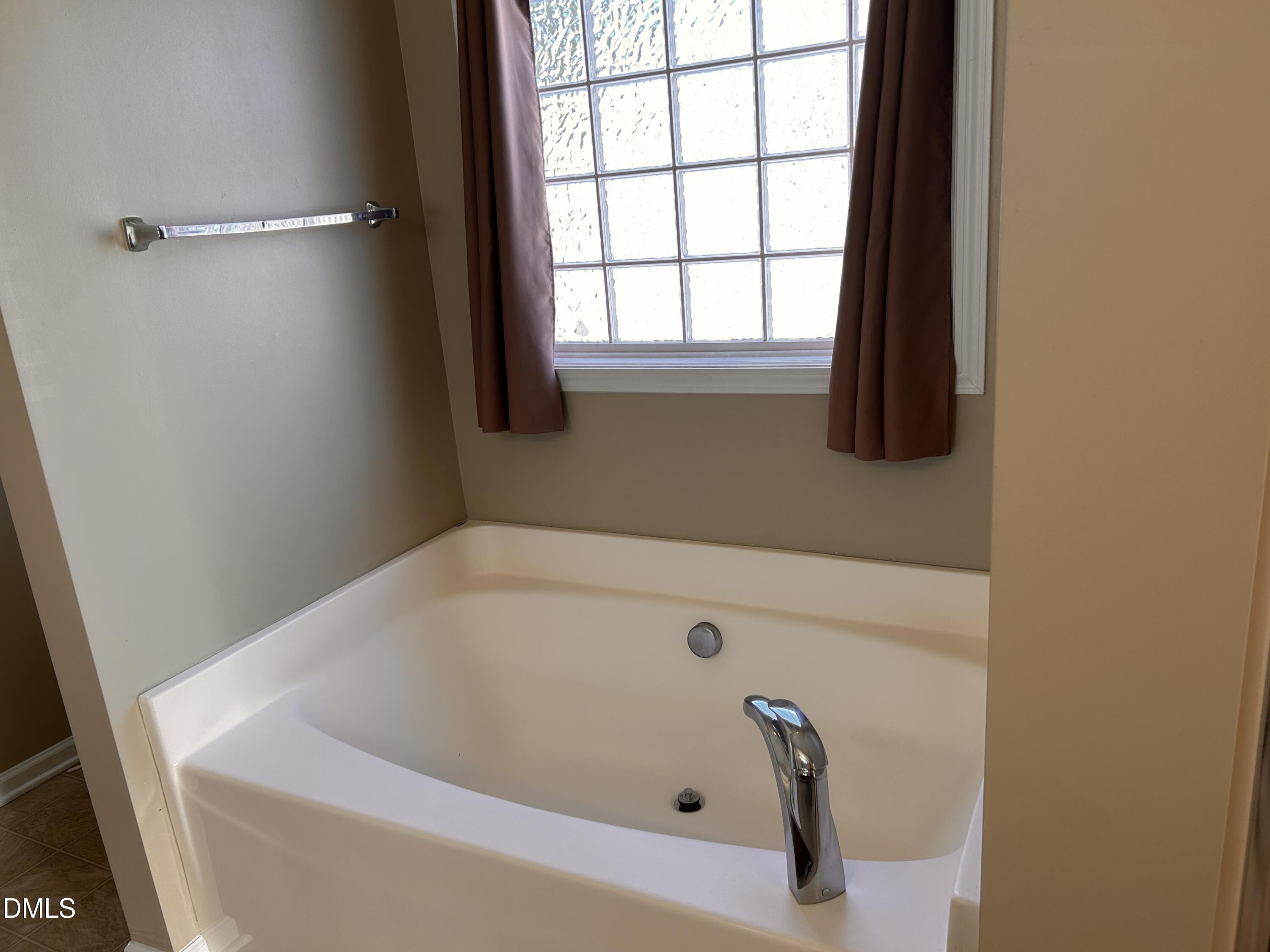 3920 Cane Garden Drive Raleigh, NC 27610 - Photo 15 of 23 a bathroom with a tub