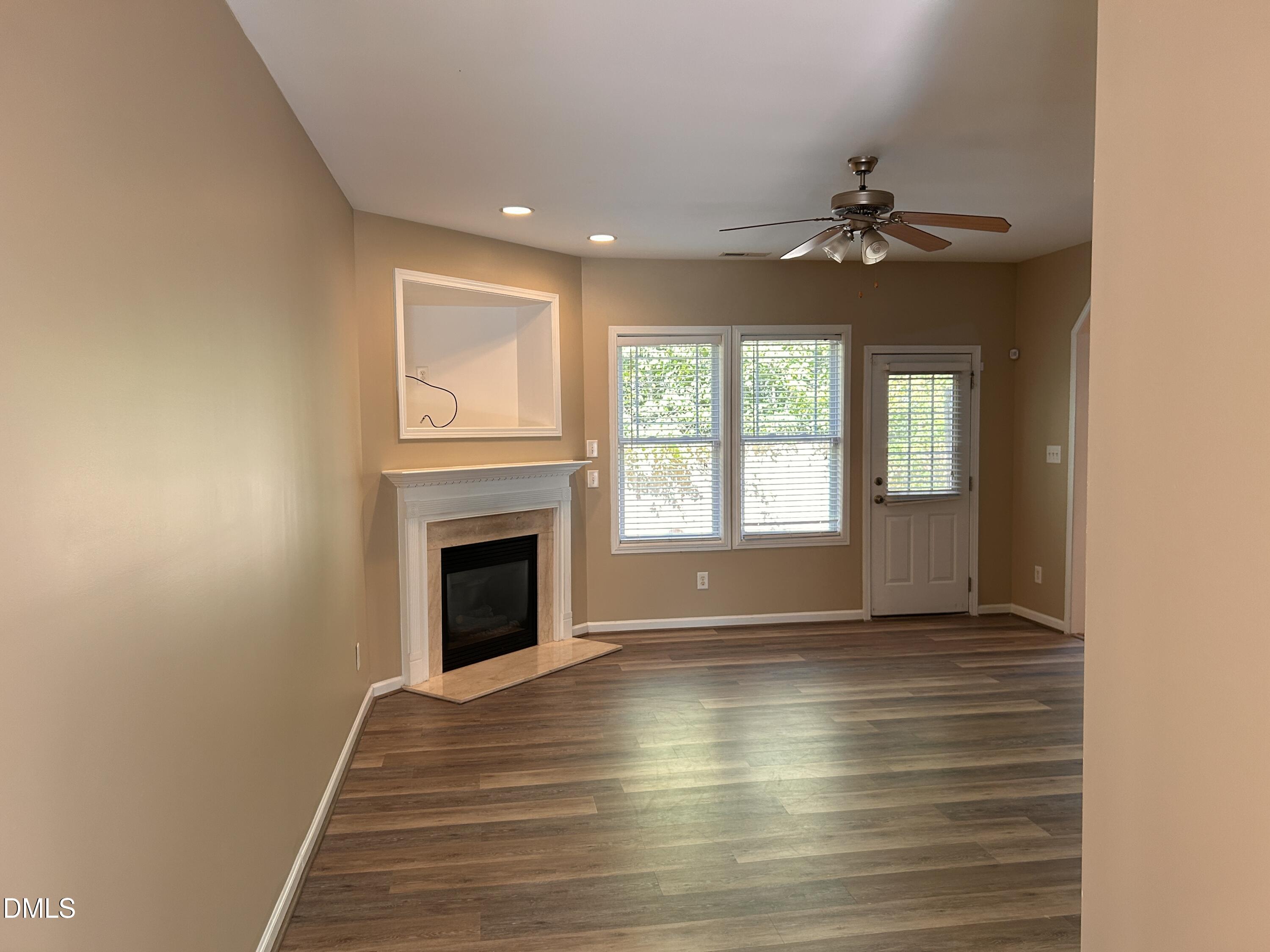 3920 Cane Garden Drive Raleigh, NC 27610 - Photo 4 of 23 a view of an empty room with a window and fireplace