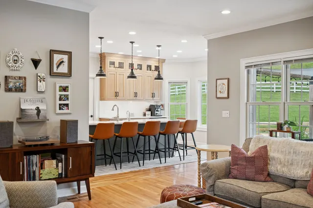 a kitchen with stainless steel appliances kitchen island a table and chairs in it