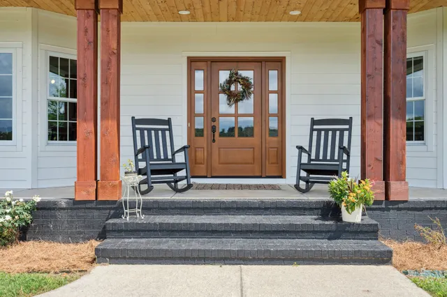a front view of a house with a garden