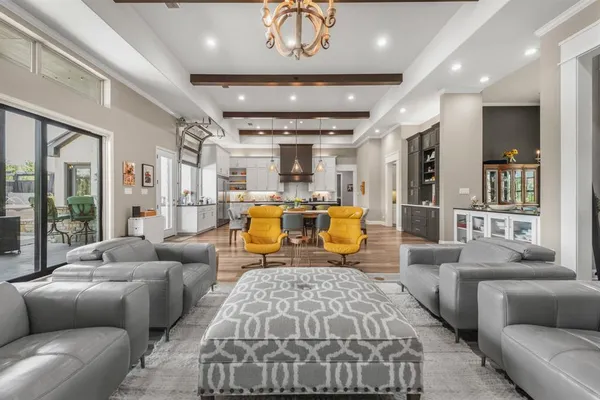 a living room with furniture and a chandelier