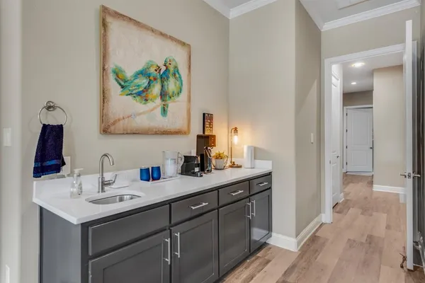 a bedroom with a bed a flat screen tv and a couch