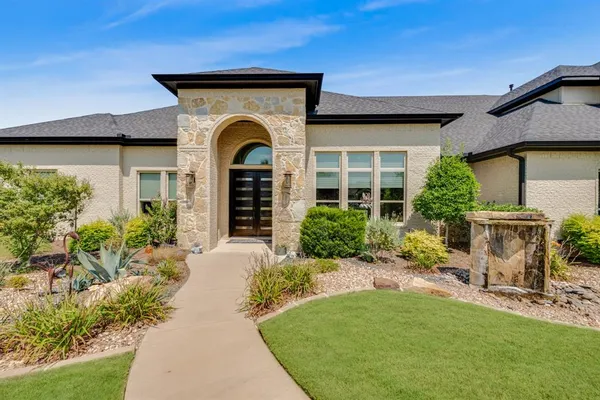 a front view of a house with garden