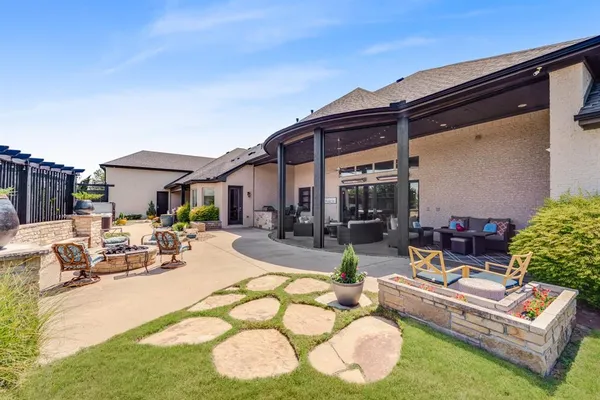 a view of a house with backyard and sitting area