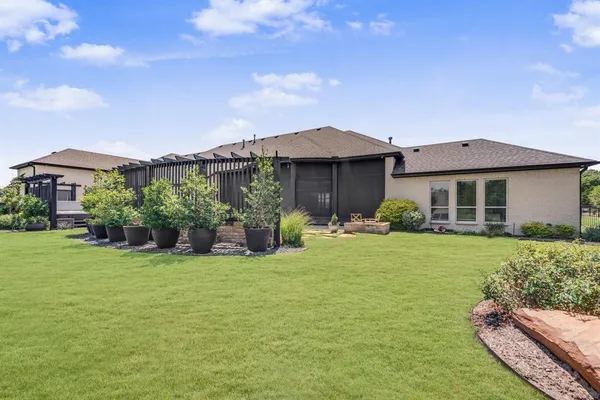 a view of a backyard with sitting area and furniture