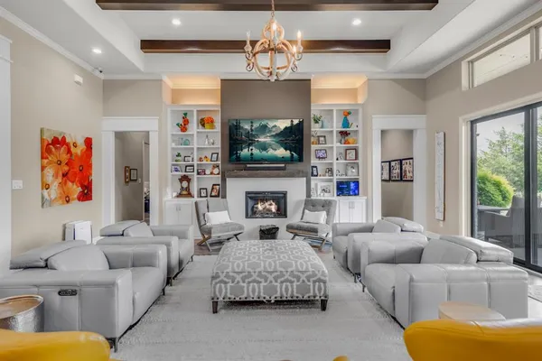 a living room with furniture a fireplace and a flat screen tv