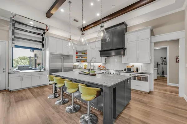 a kitchen with a stove a sink and a refrigerator