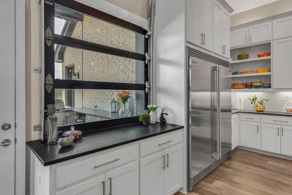 a kitchen with stainless steel appliances a sink and a refrigerator