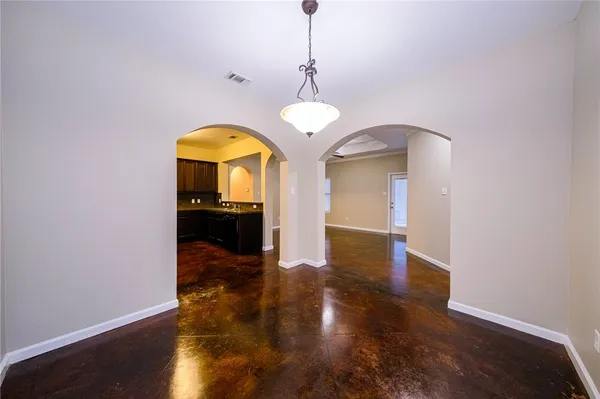 a view of a room with wooden floor staircase and a chandelier