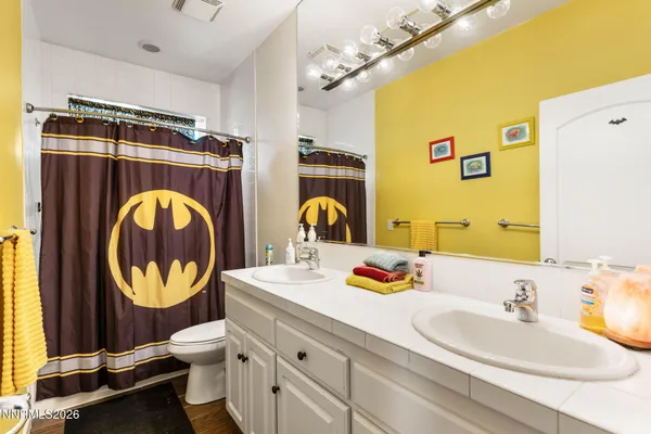 a bathroom with a sink mirror and toilet