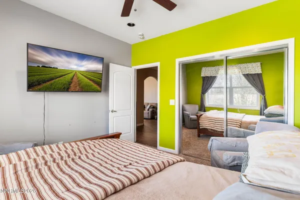 a bedroom with a bed and a flat screen tv